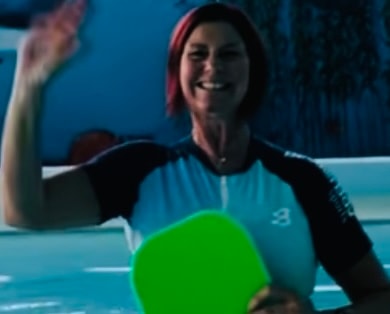 Rebecca Atkinson, swimming coach, teaching a child in the pool